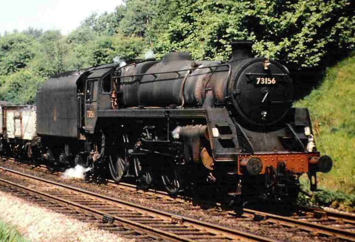 Hard at work in the dying days of steam, Class 5 4-8-0 (successor of the LMS 'Black 5') 73156 pounds the rails with a mixed freight