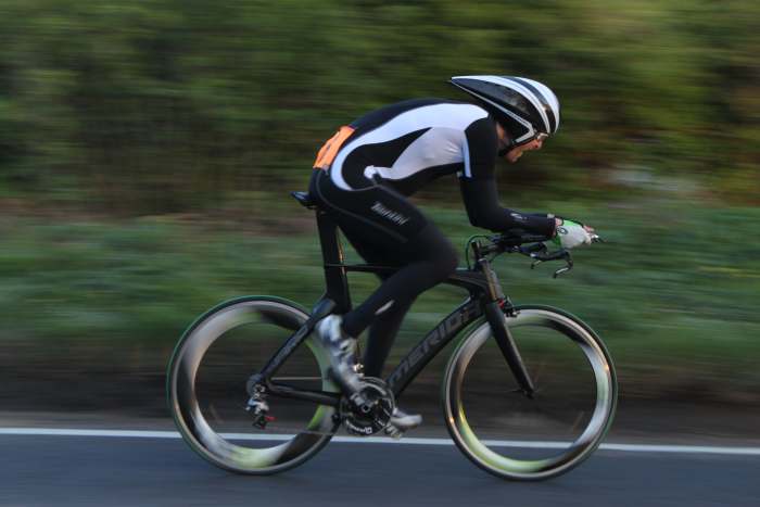 Play around with camera settings to blur the background in your cycling photo's. Shutter speed 1/60 sec, f value 5.6, ISO 200