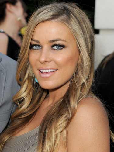 Carmen Electra with medium ash blonde hair, long and slightly curled. Celebrities with medium ash blonde hair.