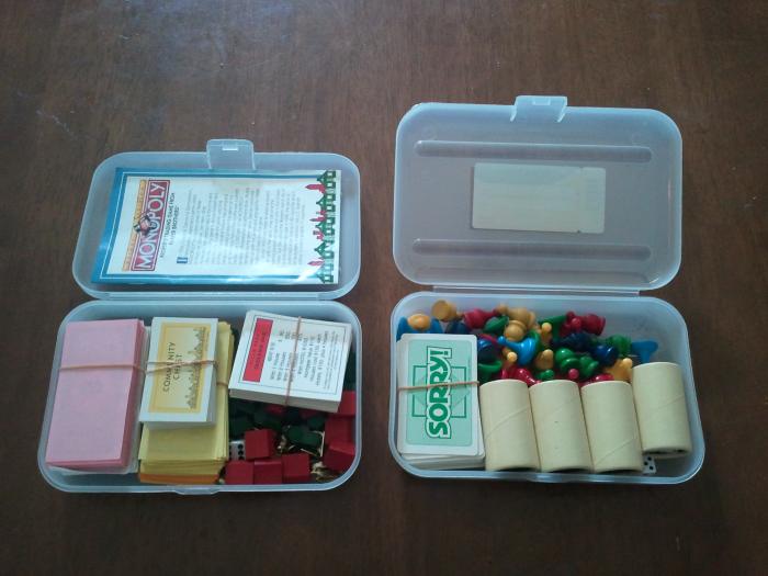 Placing the games pieces, money, cards, dice etc. into the pencil boxes to save space. The box on the left contains all the pieces etc. for the game of Monopoly and the one on the right contains the pieces for both Parcheesi AND Sorry.