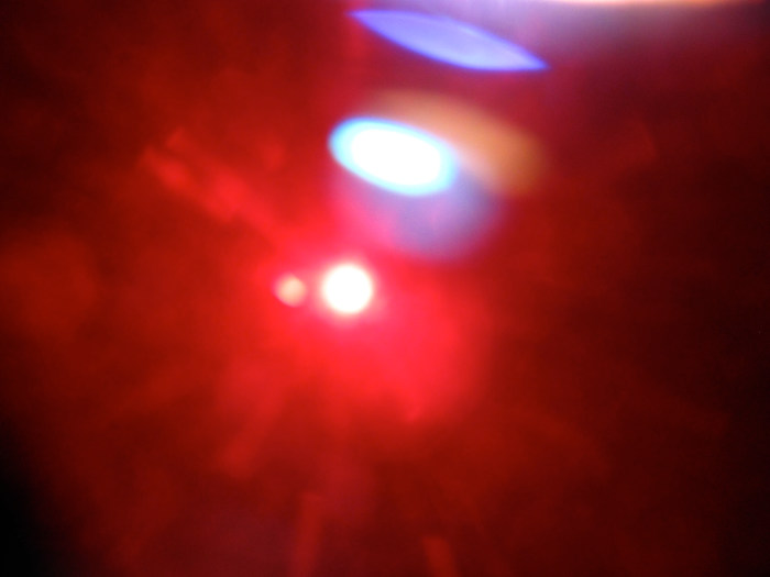 The next one I took at 12:53 p.m. on Sunday Sept. 23, 2012 and it has moved down the side of the Sun. The blobs of light above are from light getting under the floppy disk's as the blow in the breeze.