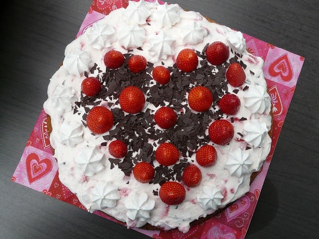 This is a beautifully decorated Million Dollar Pie. It has whole strawberries and dark chocolate shavings on it.