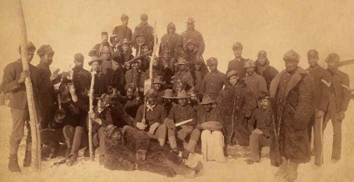 Buffalo soldiers of the 25th Infantry, some wearing buffalo robes, Ft. Keogh, Montana; 1890.