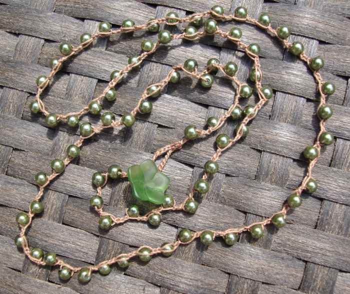 These are pretty glass faux pearls in an olive green color. This chain is made from thin cotton thread, not as thick as the cording. I used a glass flower and loop for the clasp.