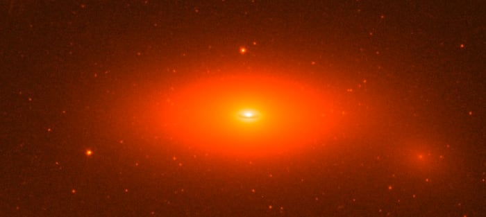 Even by supermassive standards, this black hole's is big: it's the mass of 17 BILLION suns, 14% of its whole galaxy's mass, and the black hole itself is as wide as 11 times Neptune's orbit.