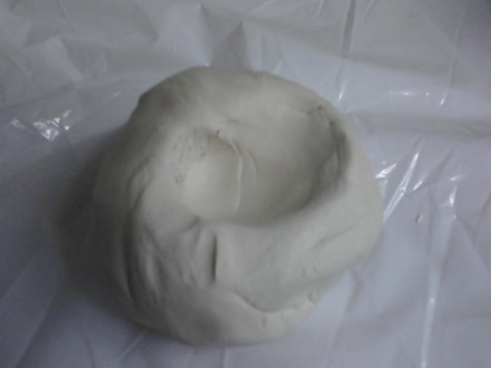 Start by making a depression in the ball of clay with the thumbs, placing the fingers on outside of ball, begin pinching fingers and thumbs together