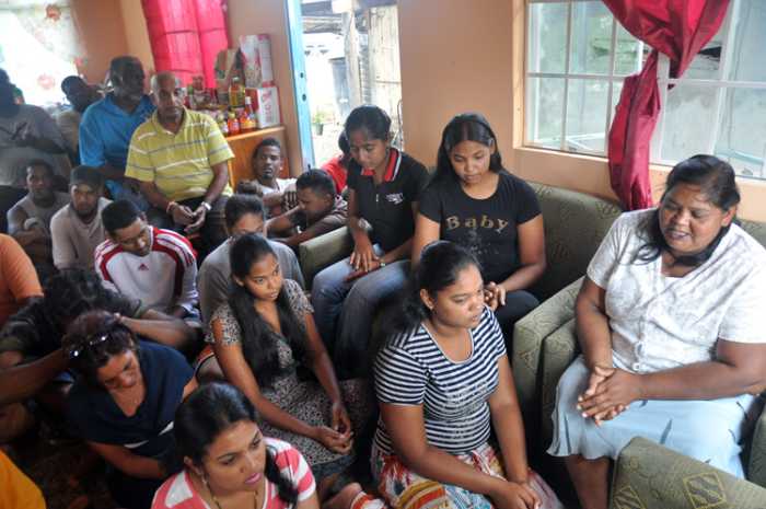 The family that blessed that volunteers with an opportunity to serve is seated for the prayer session.