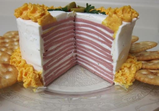 Baloney Cake: Baloney layered in between a mixture of cream cheese and ranch dressing, along with aerosol sharp cheddar cheese and crackers. Bring this to your next party!