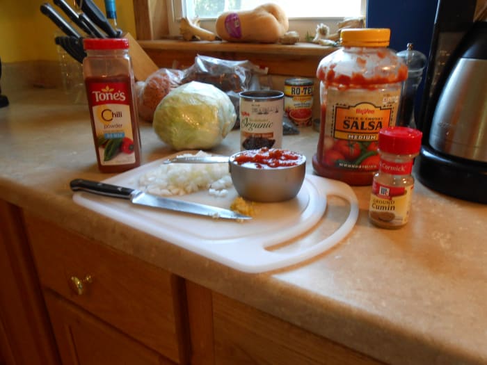 Ingredients for Spicy Vegetarian Chili include: cabbage, onion, garlic, black beans, sweet corn, salsa, cumin, chili powder, salt and pepper.
