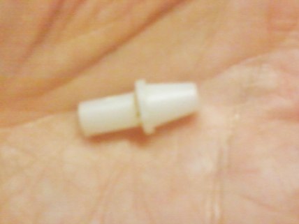 The candle, completely unraveled, shows the hard plastic tip which gives the end of the candle stability.