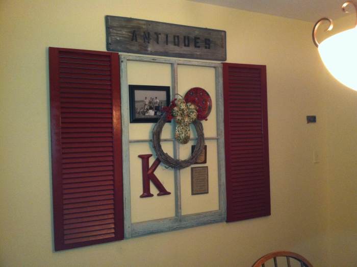 Wall grouping consist of free shutters, old window also free, decorator plate, large letter, wreath and ribbon all thrift or dollar store finds, family photo downloaded from phone enlarged and printed, $1 frame from dollar tree $10 all in!