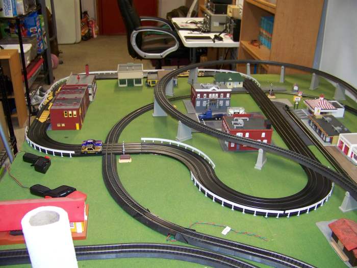 Try to beat the train with your slot car! Like-Like makes an adapter that allows to to create a slot car / track intersection for just such fun!