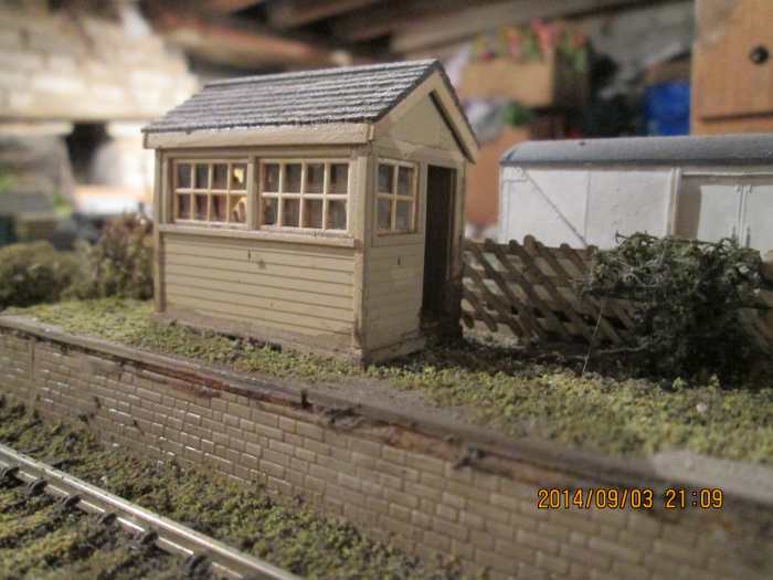 The signal cabin, door ajar, ready for the porter signalman to attend to the point-settings for when the branch pick-up goods comes, shunts and leaves again the way it came