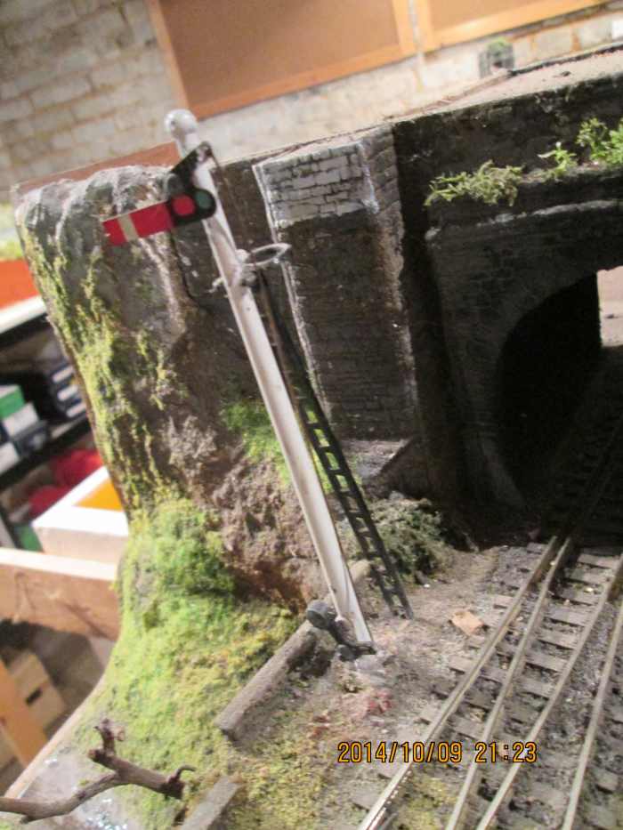 The Hornby starter signal at 'on' means a train could be due or the line is occupied - the tunnel entrance is boxed in to darken it, make it a touch more realistic