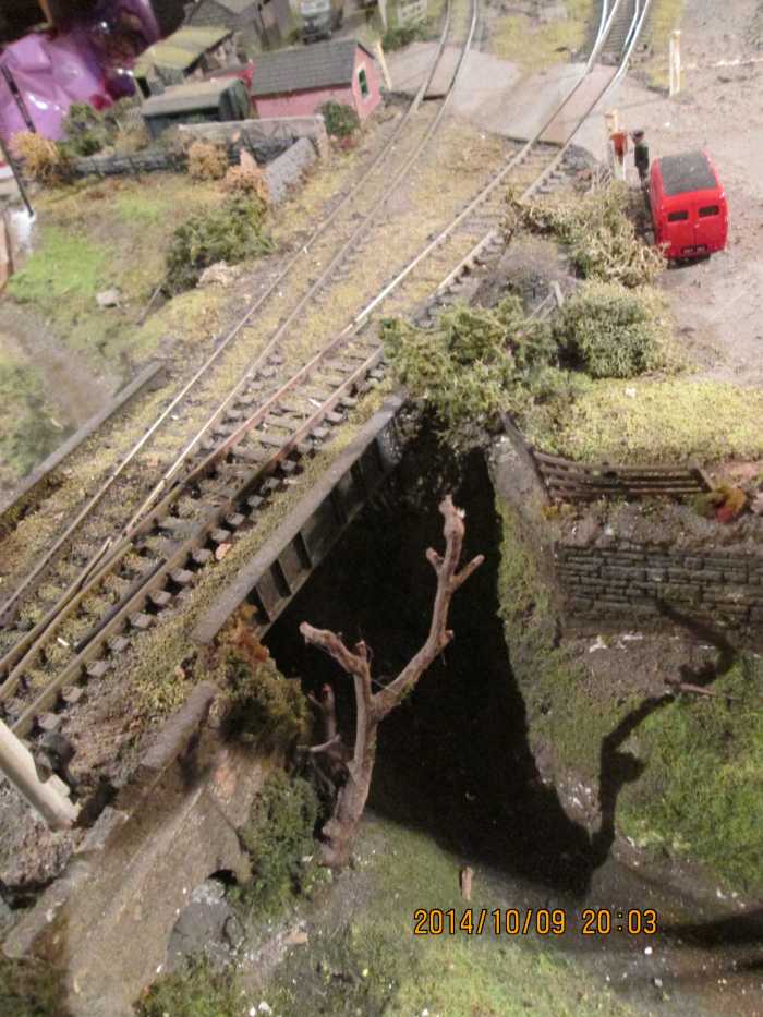 The view down onto the bridge, showing the top of the abutments and a leaf-bare tree trunk (twig taken from the edge of Wanstead Flats recreation area)