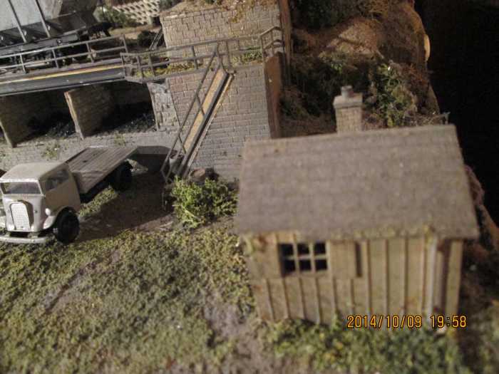 The old coal office with the steps up to the rail deck, a short flatbed lorry such as the one left would be used as a coal delivery vehicle (white metal kit with clear plastic 'glazing', built by supplier)