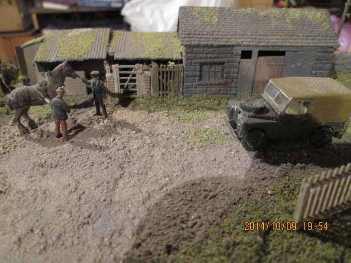From left to right, privy, store shed pigsty, smithy - the farmer chatting to the stationmaster (left) and someone's Land Rover (Oxford Diecast) parked blocking the warehouse entrance