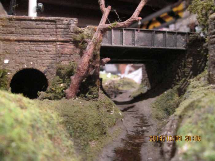 From the front, livestock underpass or 'cattle creep'behind that tree, the girder sidewall and abutments on the station side