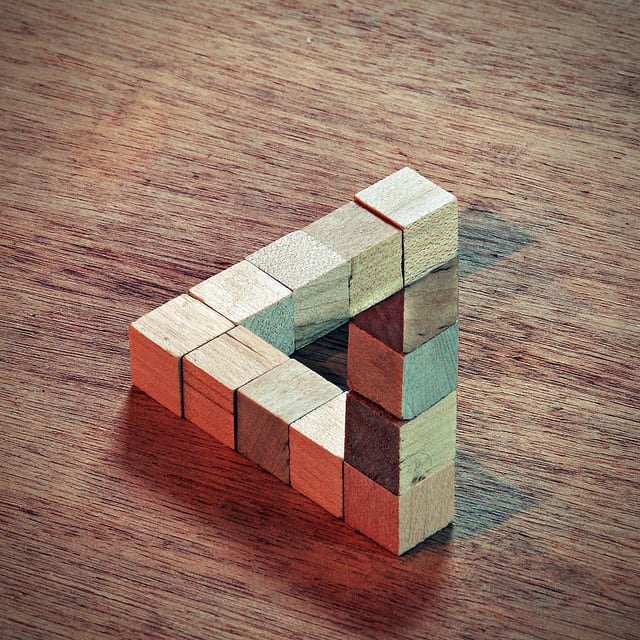 This visual illusion was created in photoshop. Built from wooden blocks, two images were combined digitally with crop and curve adjustment layers added to add to the illusion