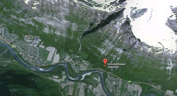 Vinnufossen Falls are located in Norway starting at the top of a very steep cliff side of a large mountain ending in a valley below. This waterfall is located just above the marker in the picture where the snow starts on the mountain top.