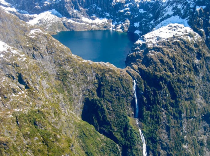 Browne Falls is located on a high mountain top in New Zealand. Because of its remoteness, Browne Falls is best viewed through a helicopter tour or boat tour or online.