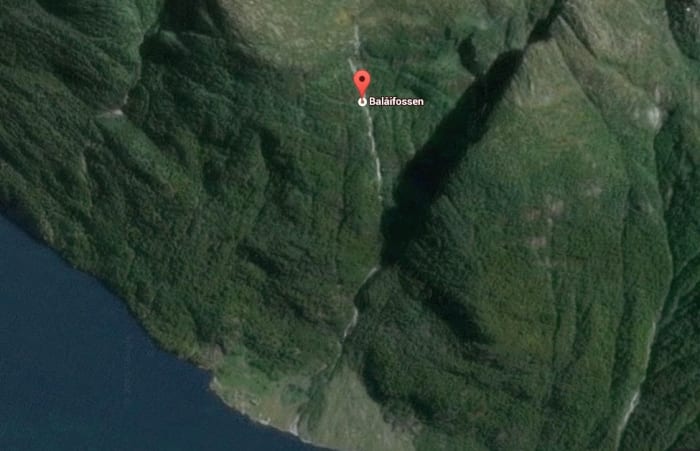 Balåifossen starts near the marker in the picture from the snow melt above and flows in the fjord below. The road to view the falls is in the lower part out of the picture.