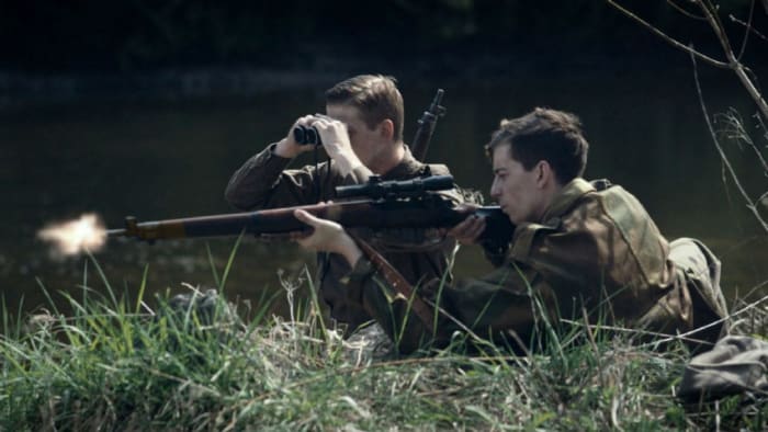 The Canadian regiment of the Black Watch - they were first over the Rhine in 1945 - re-enacts a WWII Normandy scene with rifleman and spotter to confirm his 'hit'
