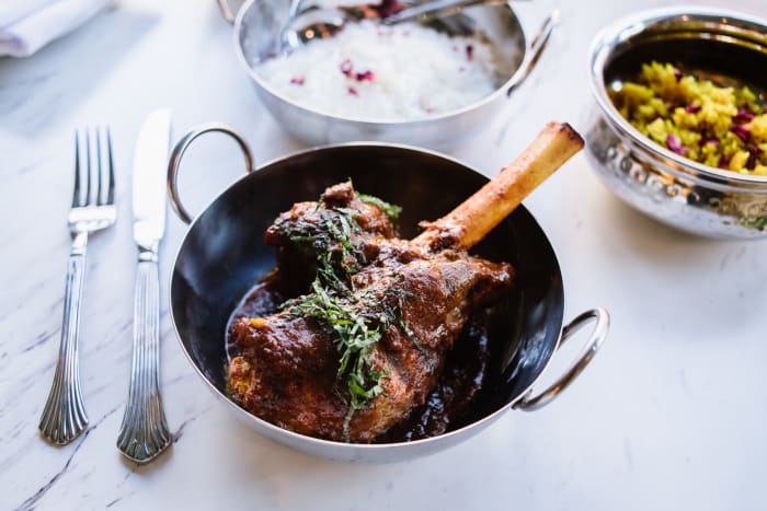 Lamb Shank Kosha Mangsho - Slowly braised lamb shank served with traditional mishti pulao with cashews.