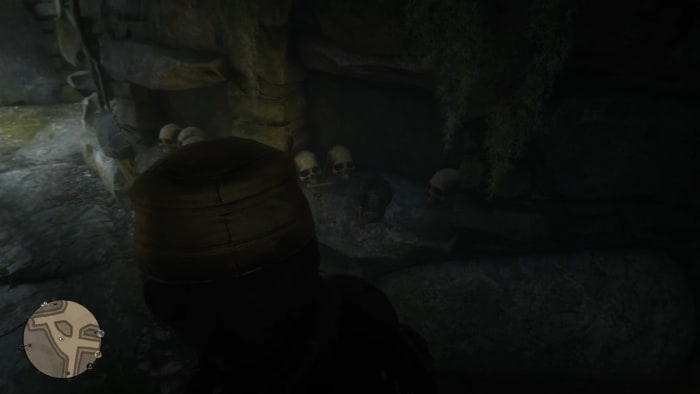 The Viking Helmet is on a stone shelf next to skulls.