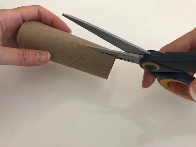 The empty toilet paper tube will be the tree trunk, so be sure to cut the slits across from each other, one on each side which is where the tree top will be inserted.