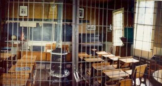 Partial view of the one-roomed Butler Township Schoolhouse #2 at Walnut Grove - (photos pieced together...windows were not crooked as this would suggest)