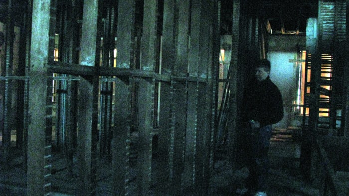 This is a strange photograph. I did NOT change the color of it in photoshop... all I did was enhance the brightness of it. The flash in my camera did not go off. This is Jon standing on the second floor with I believe to be a shadow figure behind