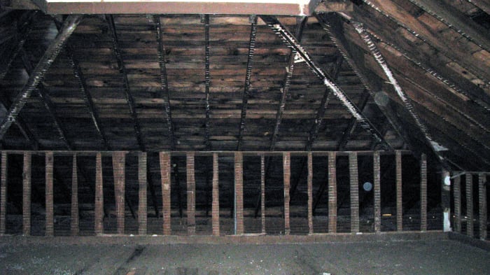 Two orbs caught in this photograph... one is between the upright boards and the other is near the ceiling, both to the right.