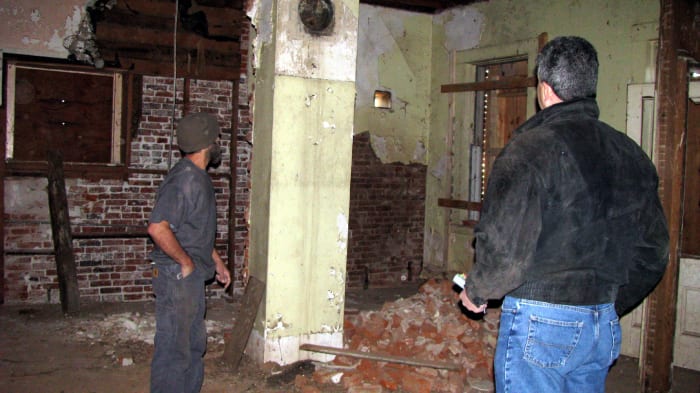 John Crane (left) and John Almada (right) standing in what used to the the kitchen at the back of the house on the first floor.