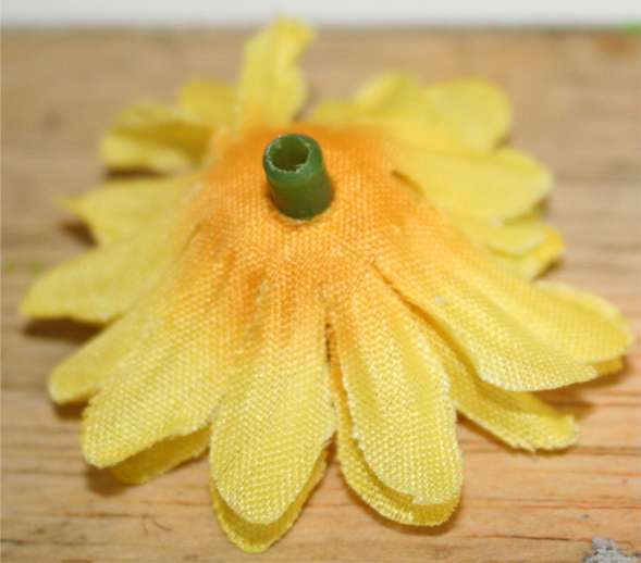 This photo shows that I've removed a plastic green piece. After this photo was taken, I cut off most of the stem and then put a small amount of hot glue where the stem and yellow material meet.