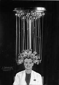 No, these aren't stills from a Fritz Lang film. They are early methods for perming....a machine made in 1923 by Icall (above) and a root winding method using tubular heaters, 1934. Images from Wikipedia