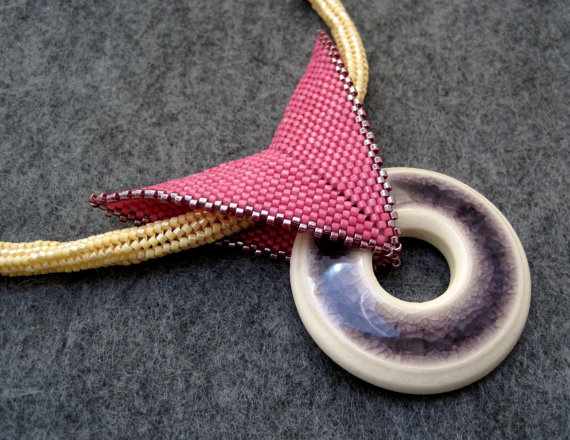 Tubular herringbone rope with a peyote bail and a ceramic donut focal.