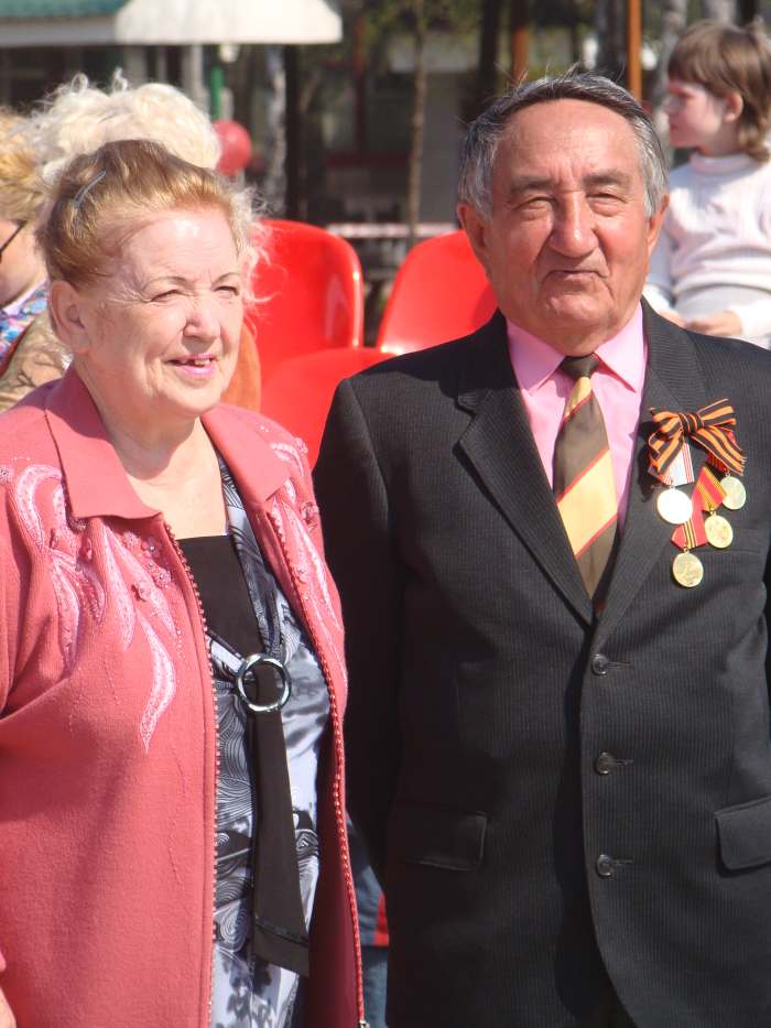 A Russian man and woman begin to remember the dead of World War II, the Great Patriotic Day celebration and holiday