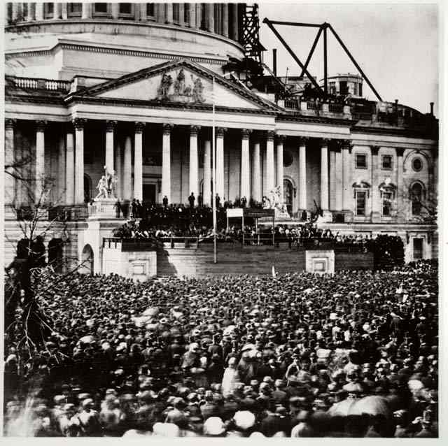 This photograph captures the crowd gathered before the east portico of the unfinished Capitol to glimpse the inaugural ceremonies.