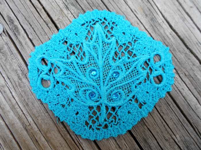A hair piece, meant to be used with a hair stick, done using Sulky lace. From the "Evenfall" collection by Urban Threads