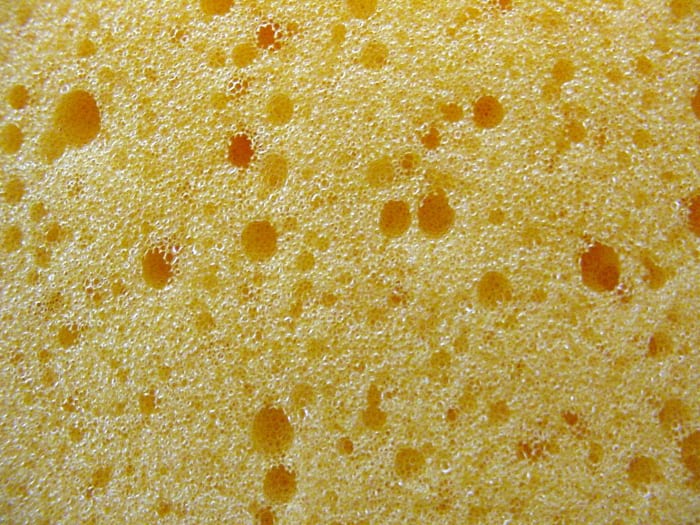 Synthetic polyester sponge cut to the proper size disc (thickness depends on the density of the sponge) will reduce the volume of soap in the Lysol No-Touch plunger pump without stressing the gears. Natural sponge may foul over time but synthetic spo