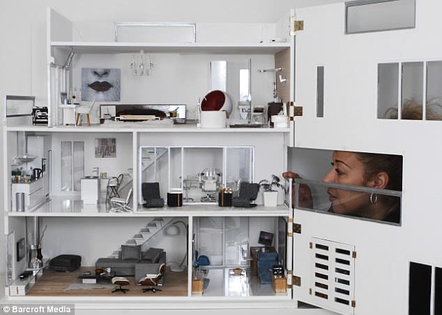 A simple and modern miniature house with a front face that can be opened and closed. The structure's interior is furnished with well crafted furniture and furnishings.