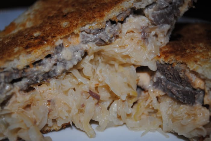 The ultimate corned beef sandwich - a Reuben. Loaded with sliced corned beef, sauerkraut and homemade Russian dressing, it's then perfectly grilled. The rye bread gets toasty and gorgeous. A thing of beauty!