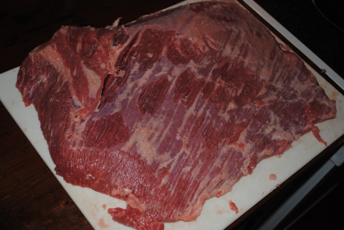 The top side of the brisket, with the fat trimmed off closely. Strictly speaking, you don't absolutely have to trim the fat off the brisket. But I find it helps the brine penetrate and flavor the brisket if you take the time to trim it.