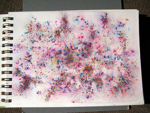 This pretty background is made by scattering watercolour pencil shavings over a water saturated page.