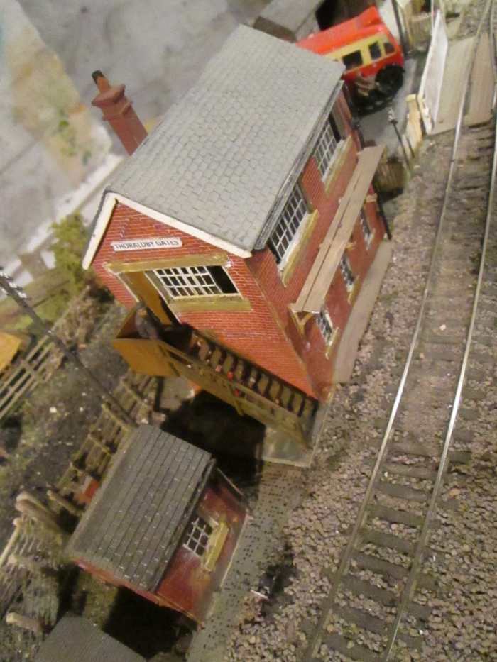 Looking down on the gate cabin roof. Window frames are sliding North Eastern type, D&S etched brass, as also supports for cabin-front walkway, (half-etches bent to support the painted plastic 'planking'). Crossing gates are Ratio, planking is Wills'