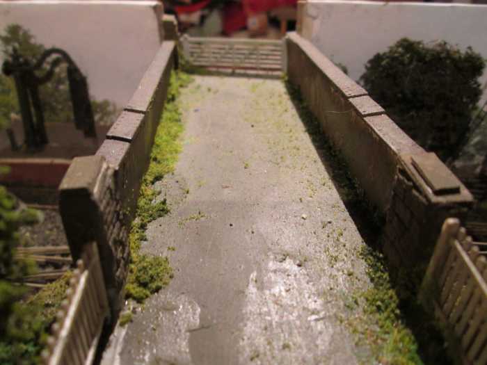 The view across the bridge - Wills' girder sections either side, road is wet & dry fine sandpaper, Ratio fencing and goods depot gate (far end)