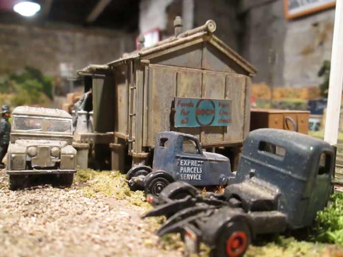 Provender stores replaced decrepit or burnt-out goods sheds to provide storage for animal foodstuffs or farm supplies with access for returned milk churns. Ratio kit painted and weathered with BOCM hoarding this end, Silcock's at front (later merged)