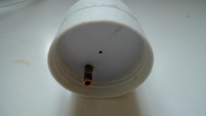 The cover of the extract container with the siphon peeping through. At the top you see how the air vent is constructed. I drilled a hole partially in the lid. It appears to be simple and very effective.