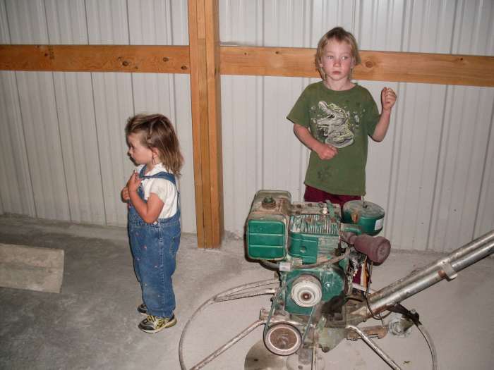 For starters, the kids were instructed to stay on the sidelines, and observe. That is a power cement trowel next to them. The building had been partially floored on a previous day.